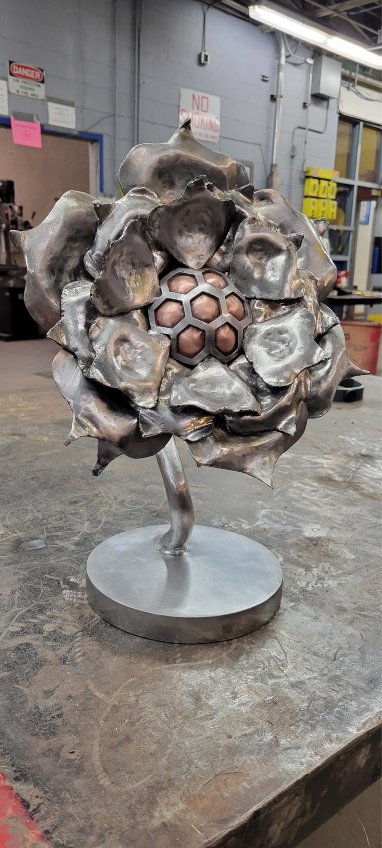 Close-up of hand-forged steel rose petals welded together in the shop